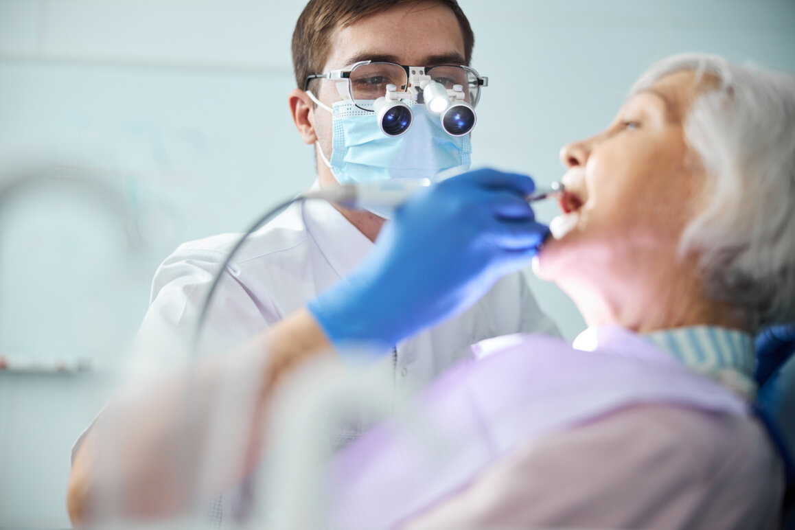 Dentist working with a senior patient at home.