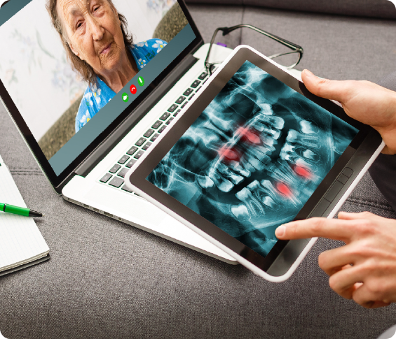 Dentist reviewing xrays with a patient during at teledenistry appointment.